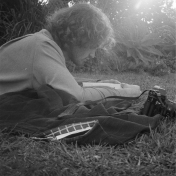 Black and white man lying in grass