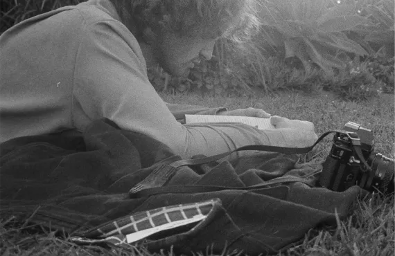 Black and white man lying in grass