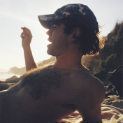 Man lying on beach not looking